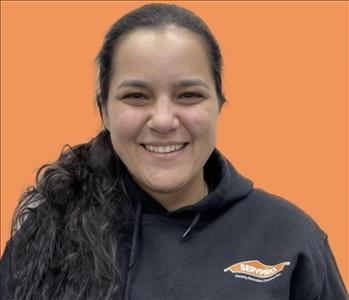 woman in front of orange wall