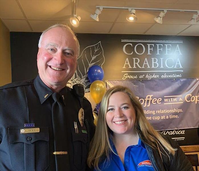 Police officer and a lady smiling 