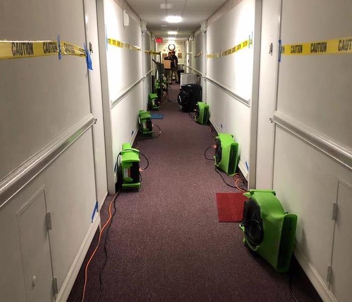 Hallway with green air movers to the side. 